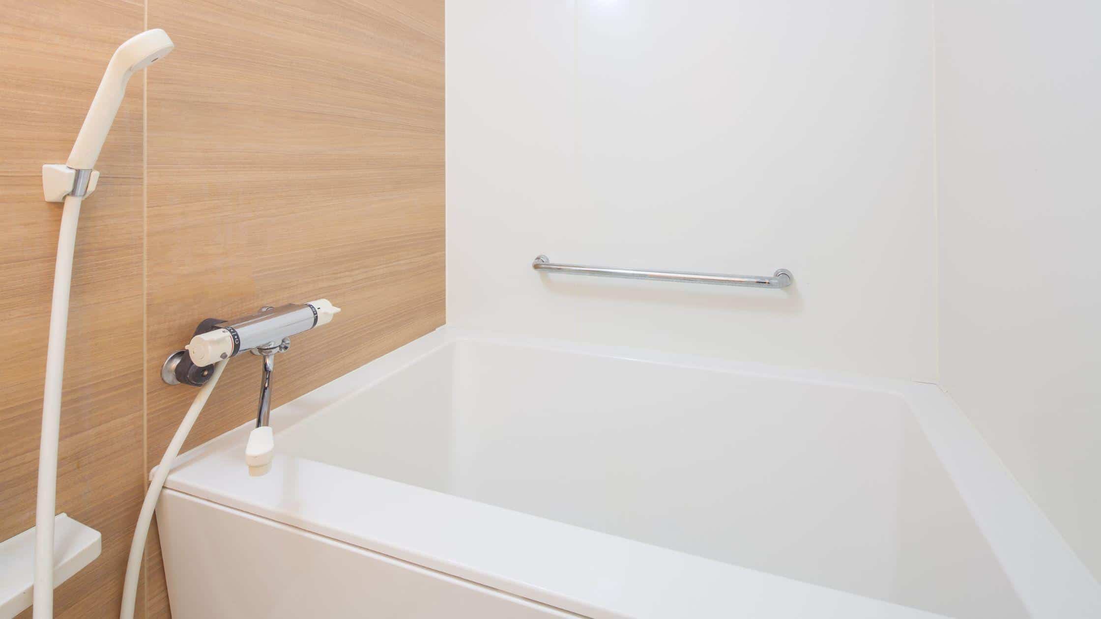 Modern bathroom with bathtub, wooden wall panel, and safety grab bar for accessible bathing.
