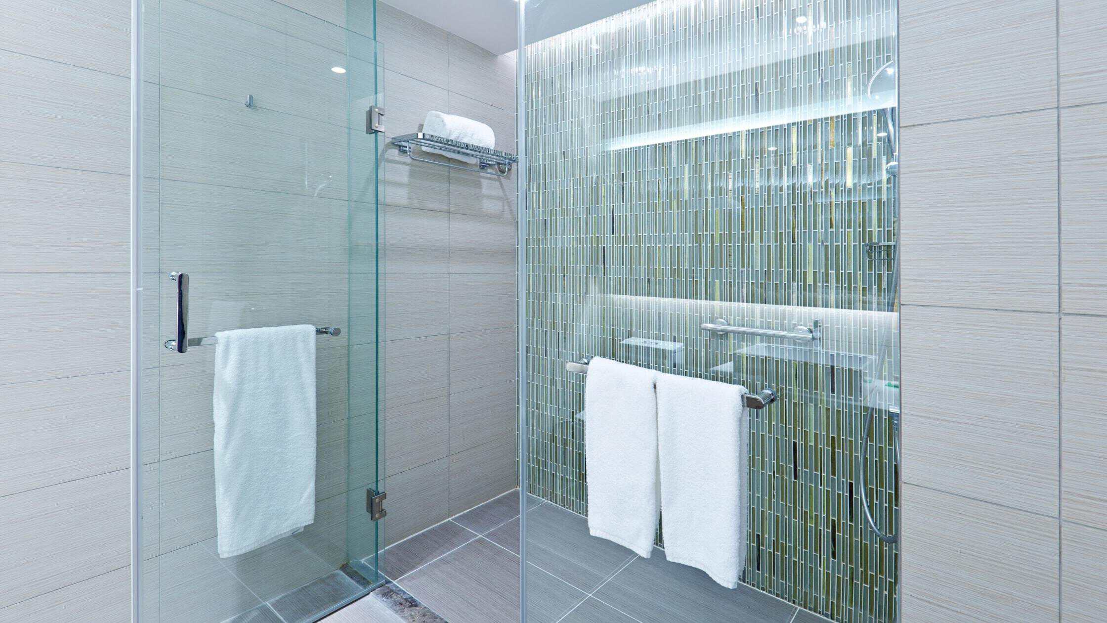 Luxury bathroom with marble walls and gold fixtures.