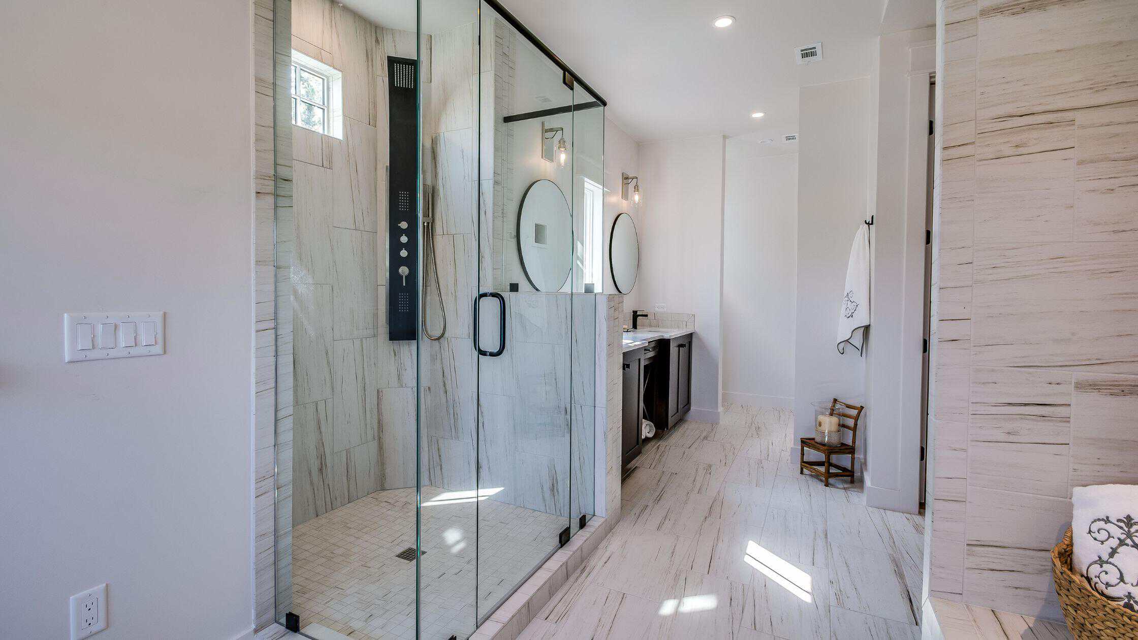Luxury bathroom with marble walls and gold fixtures.