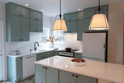 Modern kitchen with mint green cabinets and white countertops.